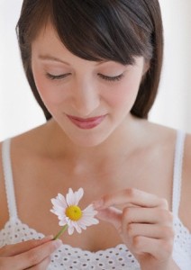 Woman plucking daisy
